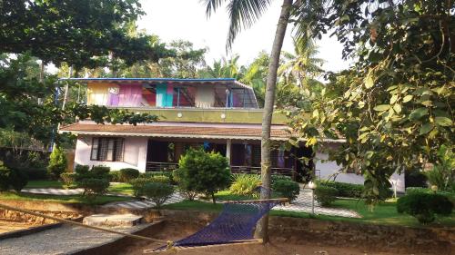 a house with a hammock in front of it at Casa Eva Luna Ayuryoga Retreat in Varkala