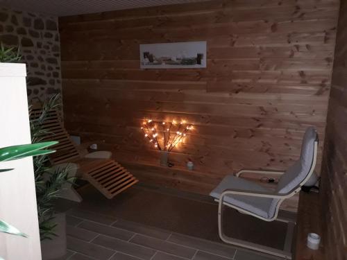 a room with two chairs and a fireplace at Gite de la Houssière in Joué-du-Bois