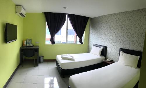 Postel nebo postele na pokoji v ubytování SARIKEI GARDEN HOTEL