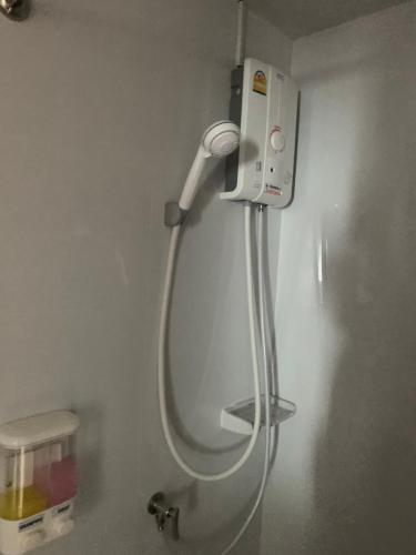 a blow dryer is attached to the wall of a bathroom at Taragrand Donmuang Airport Hotel in Thanyaburi