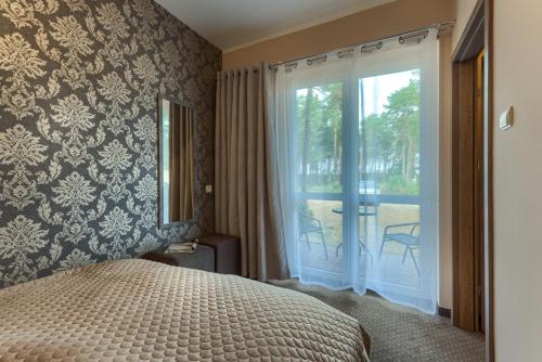 Postel nebo postele na pokoji v ubytování PONIK Apartamenty przy plaży