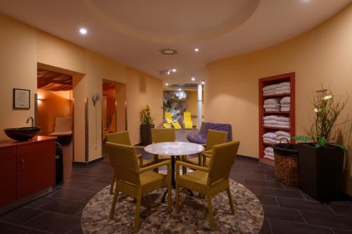 a dining room with a table and chairs at City Hotel Stockerau in Stockerau