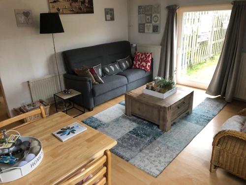 a living room with a couch and a coffee table at B&B Schoonloo - boerderij appartementen in Schoonloo