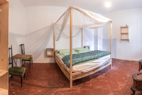 een slaapkamer met een hemelbed en een tafel bij bnb Bergamo in Bergamo