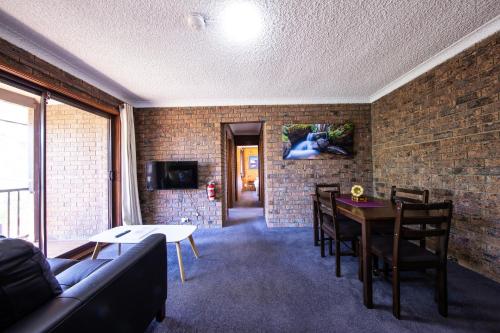 a living room with a couch and a table at Leski Club in Jindabyne
