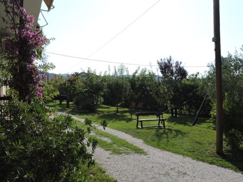 a park with a bench in the grass at Pandora Studios in Kala Nera