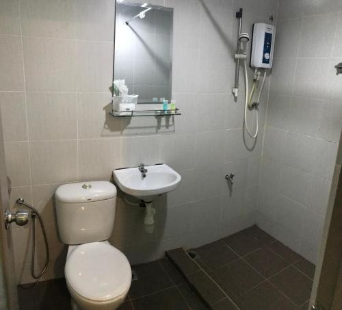 a bathroom with a toilet and a sink at SARIKEI GARDEN HOTEL in Sarikei