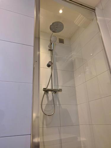 a shower with a shower head in a bathroom at PH93 Amsterdam Central in Amsterdam