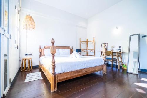 a bedroom with a bed and a table with chairs at Historic Villa in Thapae in Chiang Mai