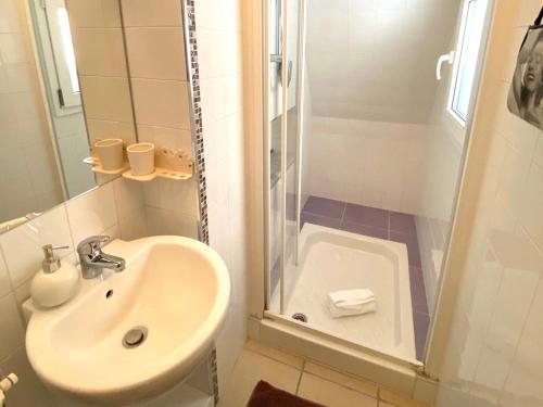 a bathroom with a sink and a shower at Le Case Nuove Room in Matera