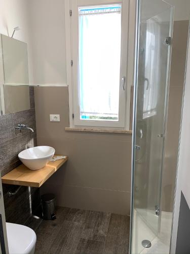 a bathroom with a sink and a glass shower at casa Cuffa in San Vito lo Capo