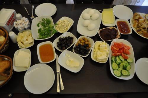 una mesa cubierta con platos y tazones de diferentes alimentos en Sakran Hotel, en Yenişakran
