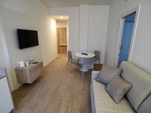 a living room with a couch and a table at Albergo Accademia in Trento