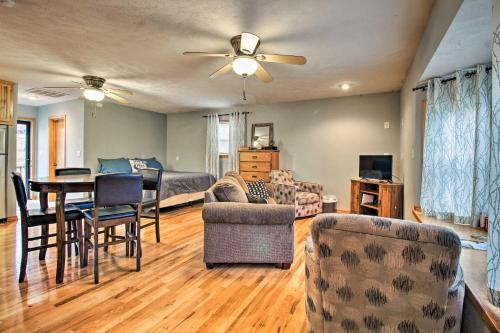 a living room with a dining table and a bedroom at Stockton Lake Escape with Kitchen, Half Mile to Lake in Stockton