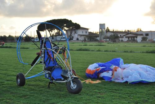 a baby stroller and a pile of trash in a field at Agriturismo Torre Cristina in Aprilia