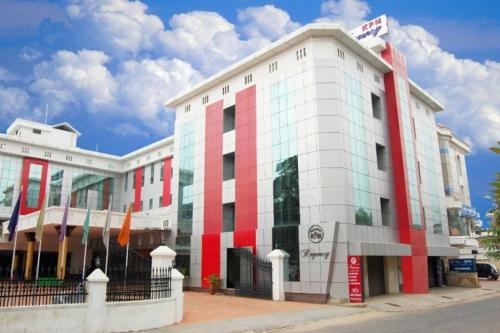 a red and white building on a city street at KPM Regency in Palakkad