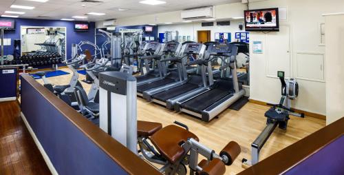 a gym with treadmills and elliptical machines at Holiday Inn Brentwood by IHG in Brentwood