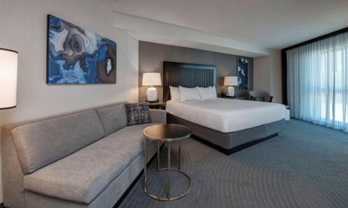 a hotel room with a bed and a couch at Hyatt Regency San Francisco Airport in Burlingame