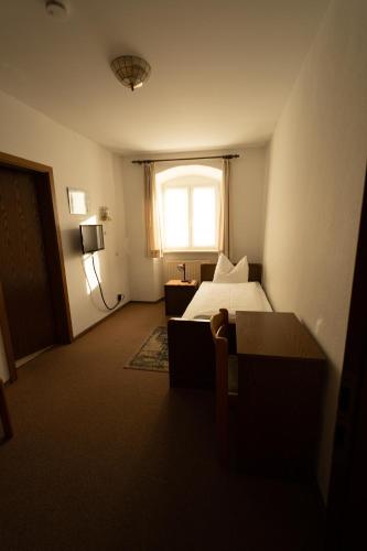 a hotel room with a bed and a window at Bistro-Pension Vis-a-Vis in Vohburg an der Donau