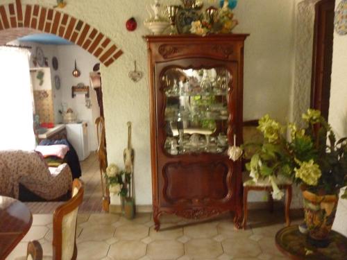a living room with a cabinet filled with dishes at Domaine De Rode Buze in Cahors