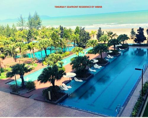 an overhead view of a swimming pool at a resort at Timurbay Seafront Residence Apartment 2 Room with garden view by imbnb in Kampung Sungai Karang