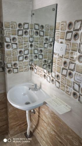 a bathroom with a sink and a mirror at Sar Raj S R RESIDENCY in Vellore