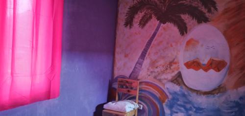 a painting of a palm tree on a wall at Ciza e Rose in Portela