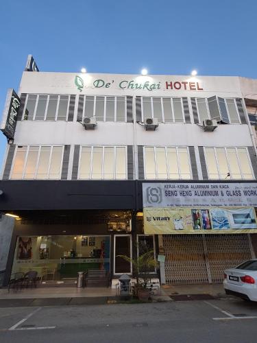 a building with a sign that reads dc chicago hotel at De Chukai Hotel in Kampong Kemaman