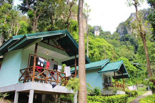 a blue house with clothes hanging on a balcony at Chill Out Bar and Bungalows in Tonsai Beach