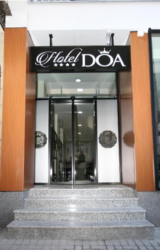 a building with a sign for a hola doa at Hotel DOA in Skopje