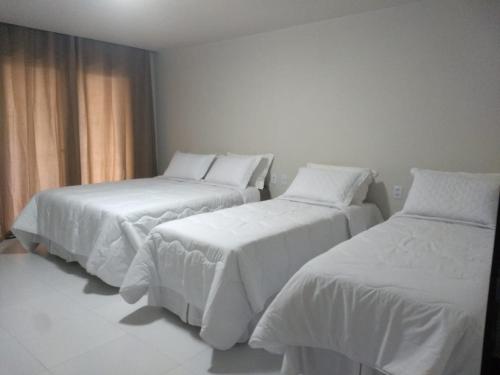 Un pat sau paturi într-o cameră la Pousada Ariús