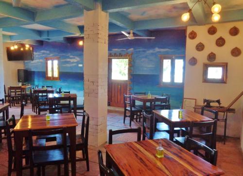 a restaurant with wooden tables and chairs in a room at Livingston Resort Hotel in Lívingston