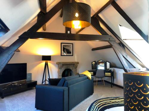 a living room with a blue couch and a fireplace at No 6 B&B in Landivy