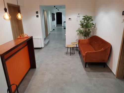 a hallway with a couch and a table and chairs at PUBYLAND ROOMS & APARTMENTS in Rogatec