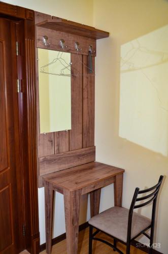 a wooden table with a mirror and a chair at ASOUR HOTEL in Goris