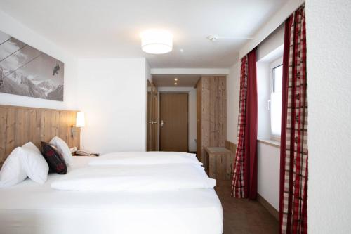 Ένα ή περισσότερα κρεβάτια σε δωμάτιο στο Hotel Bergland Superior