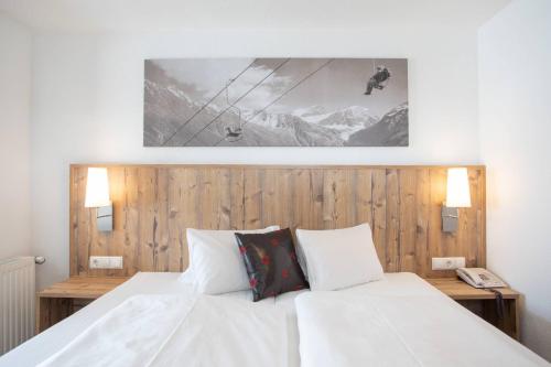 Ένα ή περισσότερα κρεβάτια σε δωμάτιο στο Hotel Bergland Superior