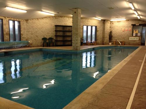 a large swimming pool in a building at Wheal Rodney Holiday Park in Marazion