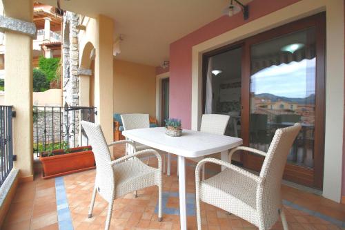 a white table and chairs on a balcony at Sa Mirada Apartments in Villasimius