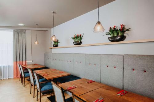 a row of tables and chairs in a restaurant at Ramada Encore Newcastle-Gateshead in Newcastle upon Tyne