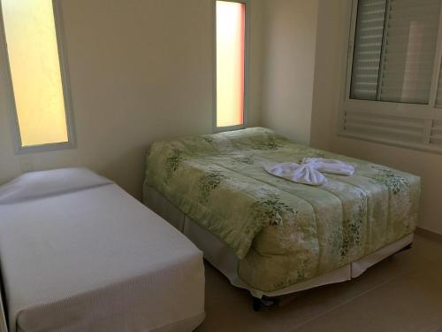 a bedroom with a bed with a towel on it at Casa Complexo Costa do Sauípe in Costa do Sauipe