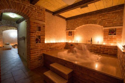 a large bathroom with a tub in a brick wall at Hotel Trim in Nikšić