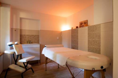 a hospital room with a table and a sink at Pension Styl in Bedřichov