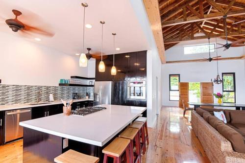 a kitchen with a large white island in a room at Vivaro Roatan North House in West End