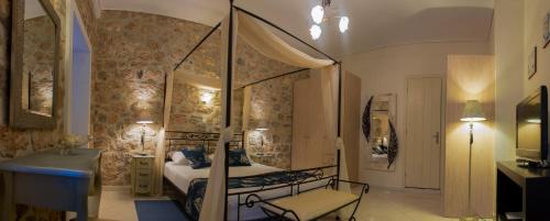 a bedroom with a canopy bed in a room at Paradiso in Hydra
