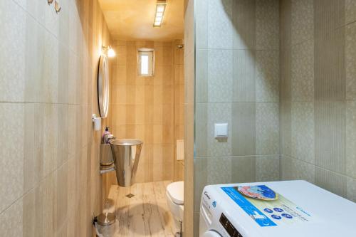 a small bathroom with a toilet and a shower at Blue Тerrace Apartment Top Center in Varna City