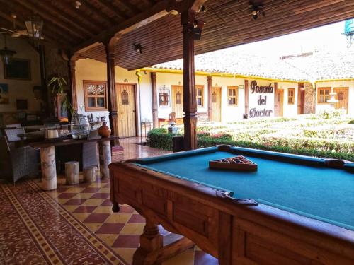 a pool table in the middle of a room at Hotel La Posada del Doctor in León