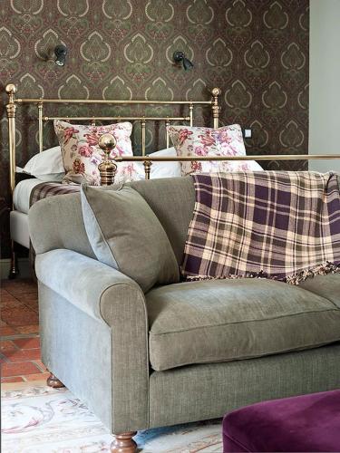 a living room with a couch and a bed at Country House Duinhof in De Haan