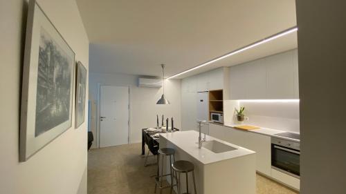 a kitchen with white cabinets and a white counter top at JASALPI único apartamento delante del Lago de Banyoles in Banyoles