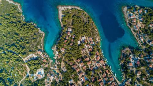 an island with houses on the shore of the water at HOLIDAY HVAR lux in Basina